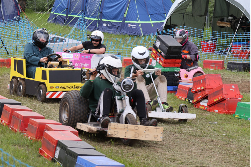 Hacky Racers racing in their small electric vehicles